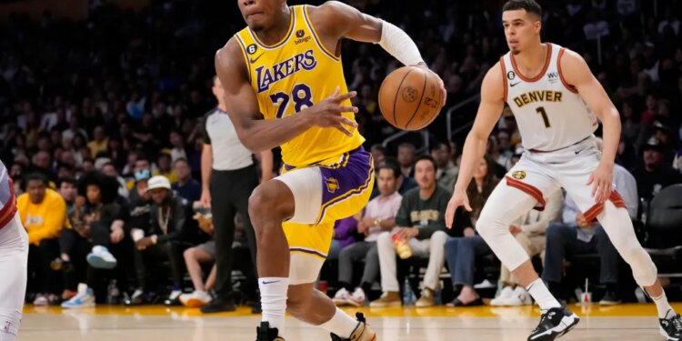 Basketball player Rui Hachimura in a Lakers uniform dribbles the ball downcourt while being guarded by Michael Porter Jr. in a Denver Nuggets uniform.