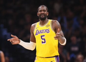 Deandre Ayton in a yellow Lakers jersey with the number 5, looking distressed.