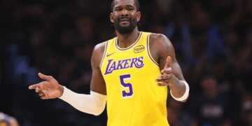 Deandre Ayton in a yellow Lakers jersey with the number 5, looking distressed.