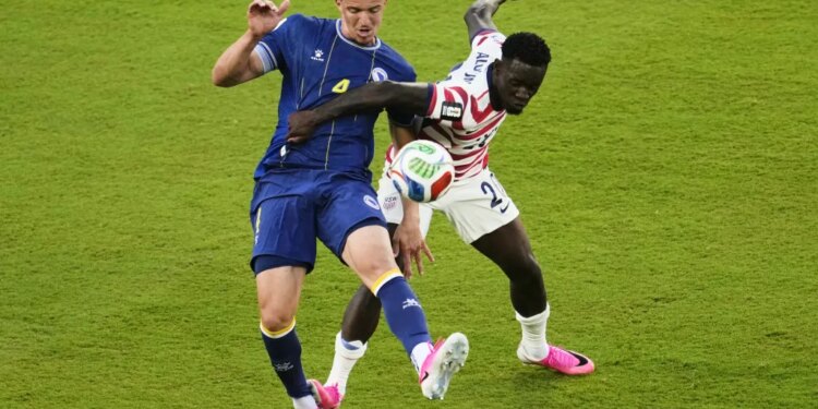 Folarin Balogun and Tarik Muharemovic challenge for the soccer ball.