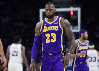 LeBron James wearing a purple Lakers jersey with number 23.