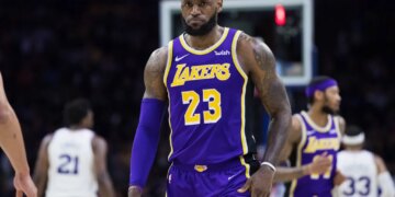 LeBron James wearing a purple Lakers jersey with number 23.