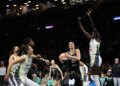Sabrina Ionescu drives past Dallas Wings defenders during a WNBA game.
