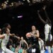 Sabrina Ionescu drives past Dallas Wings defenders during a WNBA game.