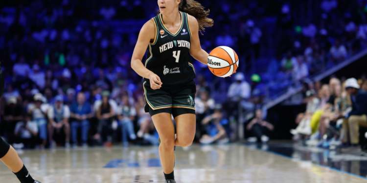 New York Liberty guard Marine Fauthoux dribbles the ball up court.