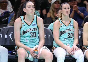 Breanna Stewart (left) and Sabrina Ionescu wear dejected expressions on the bench during the Liberty's loss to the Wings on July 7, 2026.