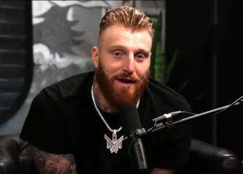 Maxx Crosby speaking into a microphone.