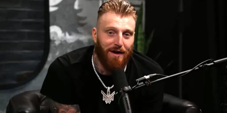 Maxx Crosby speaking into a microphone.