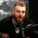 Maxx Crosby speaking into a microphone.