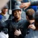 New York Mets left fielder Juan Soto (22) smiling in the dugout after scoring on a SAC fly by New York Mets shortstop Bo Bichette (19).