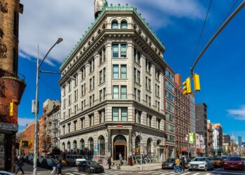 The 190 Bowery building, a large corner building with a green roof, in New York, New York.