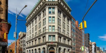The 190 Bowery building, a large corner building with a green roof, in New York, New York.