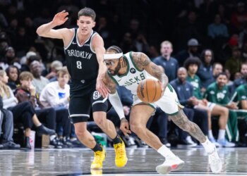 Gary Trent Jr. driving with the basketball as Danny Wolf gives chase.