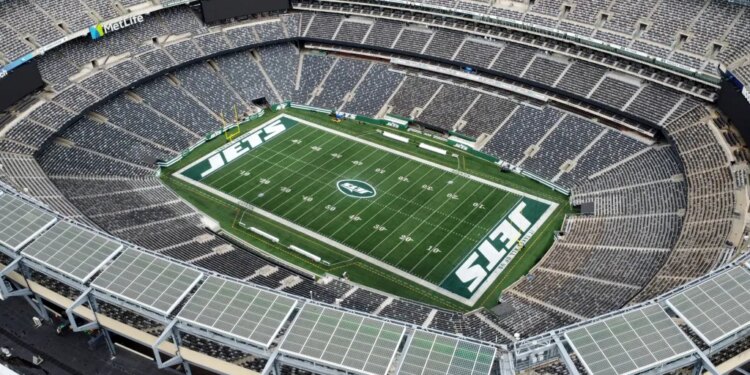 Aerial view of MetLife Stadium, home to the New York Jets and Giants, showing the empty stands and the "JETS" logo on the football field.