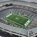 Aerial view of MetLife Stadium, home to the New York Jets and Giants, showing the empty stands and the "JETS" logo on the football field.