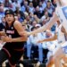 Louisville guard Mikel Brown Jr. drives against North Carolina center Henri Veesaar during a basketball game.