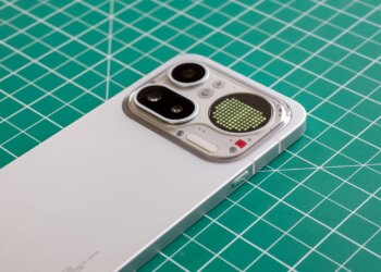 Photo of Nothing Phone 4A Pro on a green cutting mat showing the camera module with a battery level indicator on the Glyph Matrix