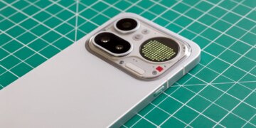 Photo of Nothing Phone 4A Pro on a green cutting mat showing the camera module with a battery level indicator on the Glyph Matrix