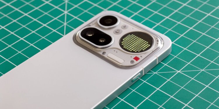 Photo of Nothing Phone 4A Pro on a green cutting mat showing the camera module with a battery level indicator on the Glyph Matrix