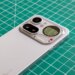 Photo of Nothing Phone 4A Pro on a green cutting mat showing the camera module with a battery level indicator on the Glyph Matrix