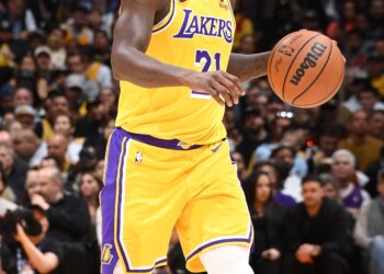 Basketball player Patrick Beverley dribbling the ball on the court.