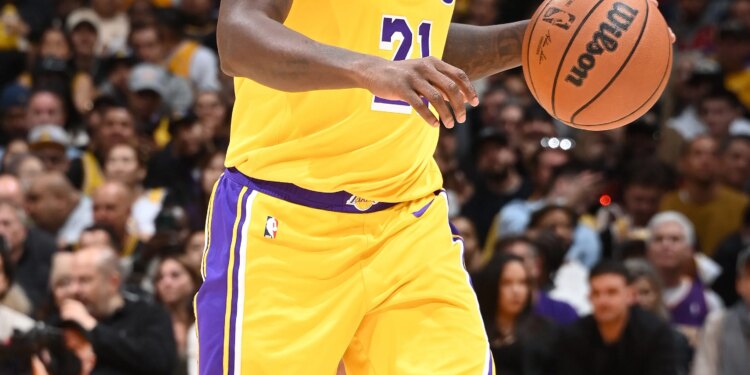 Basketball player Patrick Beverley dribbling the ball on the court.