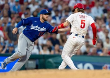 Max Muncy tags out Bryson Stott during a baseball game.
