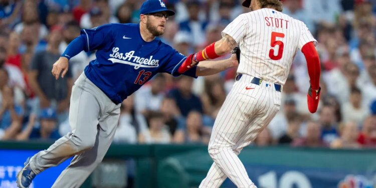 Max Muncy tags out Bryson Stott during a baseball game.