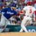 Max Muncy tags out Bryson Stott during a baseball game.