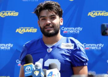 Los Angeles Rams player Stetson Bennett in a blue jersey speaking at a press conference.
