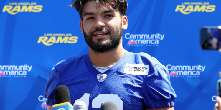Los Angeles Rams player Stetson Bennett in a blue jersey speaking at a press conference.