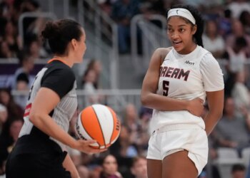 Atlanta Dream forward Angel Reese (5) talks with game official Tiara Cruse after a play against the Toronto Tempo during the second half at Coca-Cola Coliseum.