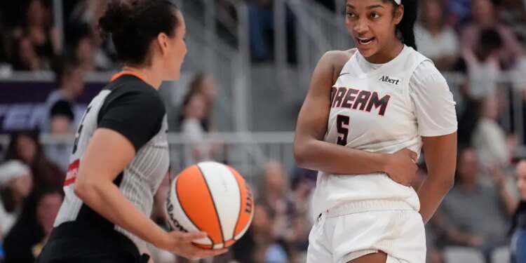 Atlanta Dream forward Angel Reese (5) talks with game official Tiara Cruse after a play against the Toronto Tempo during the second half at Coca-Cola Coliseum.