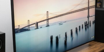 The Sony Bravia 9 II RGB LED TV on a wooden credenza with SVS speakers on either side.