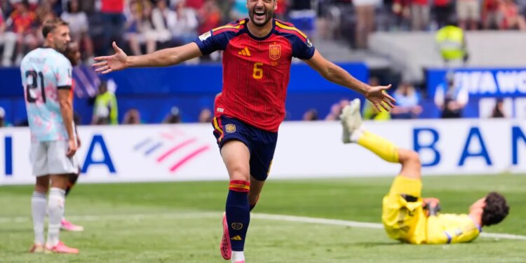 Spain's Mikel Merino (6) celebrates scoring their second goal in front of Belgium's Timothy Castagne (21) and goalkeeper Senne Lammens (12) during the World Cup quarterfinal soccer match between Spain and Belgium in Inglewood, Calif., near Los Angeles, Friday, July 10, 2026.