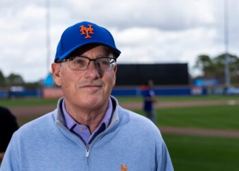 New York Mets owner Steve Cohen wearing a blue Mets cap and light blue zipped sweater at Spring Training.