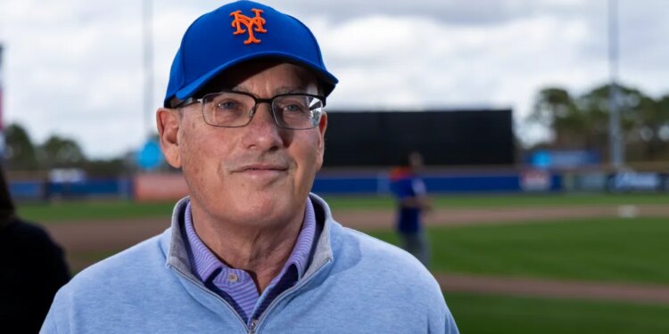 New York Mets owner Steve Cohen wearing a blue Mets cap and light blue zipped sweater at Spring Training.