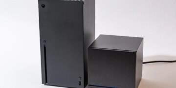 An Xbox Series X next to a Steam Machine. The Steam Machine is roughly half the size of the Series X.