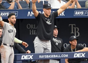 New York Yankees' Aaron Judge, center, celebrates Ben Rice's two-run home run with his team.