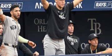 New York Yankees' Aaron Judge, center, celebrates Ben Rice's two-run home run with his team.