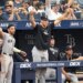 New York Yankees' Aaron Judge, center, celebrates Ben Rice's two-run home run with his team.