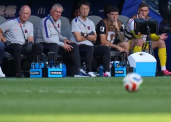 Christian Pulisic and other US players watching from the bench during the World Cup round of 16 soccer match between the United States and Belgium.