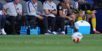 Christian Pulisic and other US players watching from the bench during the World Cup round of 16 soccer match between the United States and Belgium.