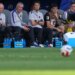 Christian Pulisic and other US players watching from the bench during the World Cup round of 16 soccer match between the United States and Belgium.
