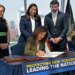 Governor Kathy Hochul signing an executive order to pause AI data center construction, with Julie Tighe, State Senator Kristen Gonzalez, and Coner Eckert in the background.
