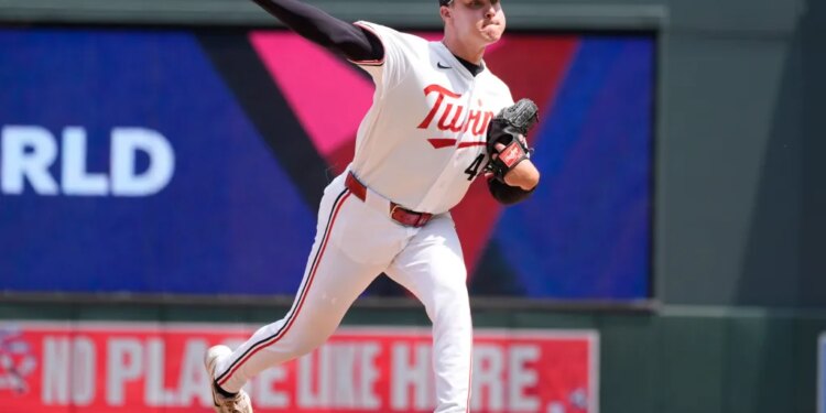 Minnesota Twins relief pitcher Cole Sands pitching in a baseball game.