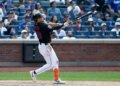 New York Mets center fielder Tyrone Taylor hitting a three-run home run.