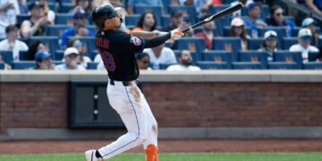 New York Mets center fielder Tyrone Taylor hitting a three-run home run.
