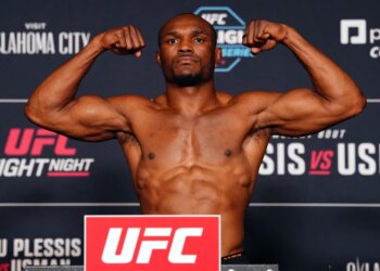 Kamaru Usman flexing during the UFC Fight Night official weigh-ins.