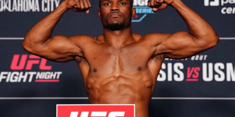 Kamaru Usman flexing during the UFC Fight Night official weigh-ins.